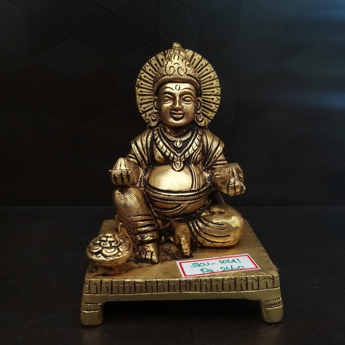 Brass Kuberar sitting on a Base Idol